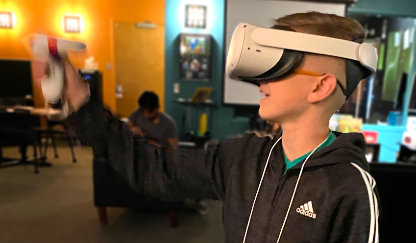 Student playing a game on VR headset