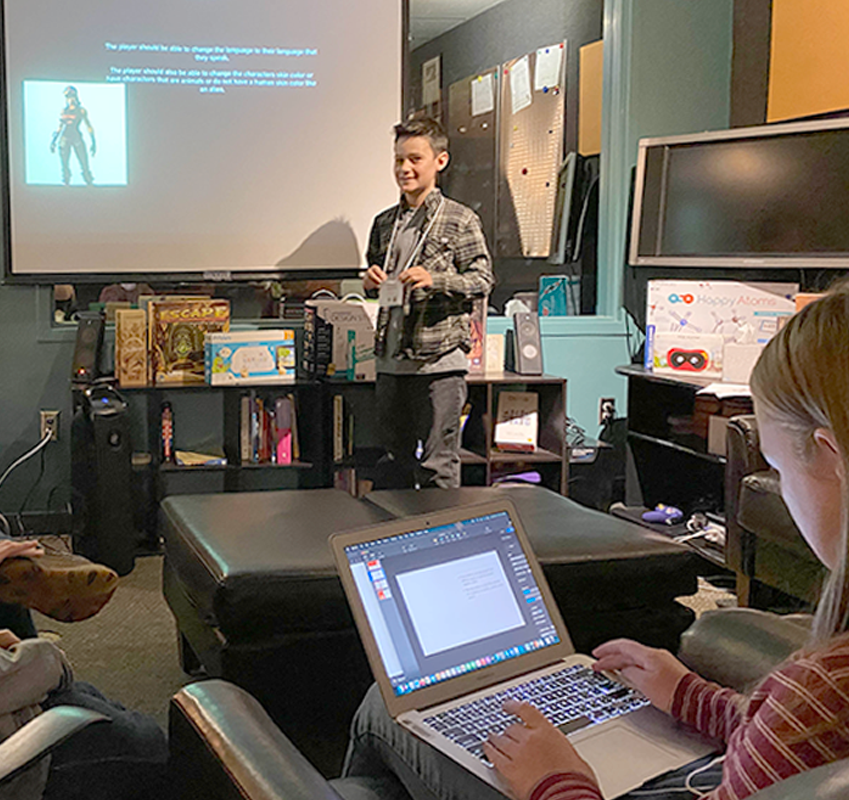 Student giving a presentation in front of a screen